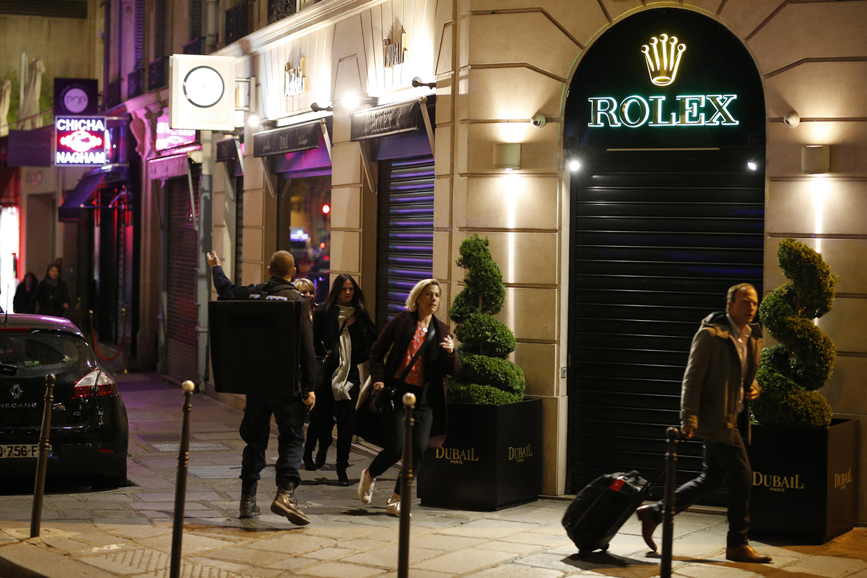 TOPSHOT - People leave a street near the site of a shooting at the Champs Elysees in Paris on April 20, 2017. French anti-terror prosecutors said they opened a probe today into the shooting on Paris's Champs Elysees that killed one police officer and wounded two others. France's interior ministry said the attacker was killed after opening fire on police in the early evening on the world-famous boulevard. / AFP PHOTO / Benjamin Cremel (Photo credit should read BENJAMIN CREMEL/AFP/Getty Images)