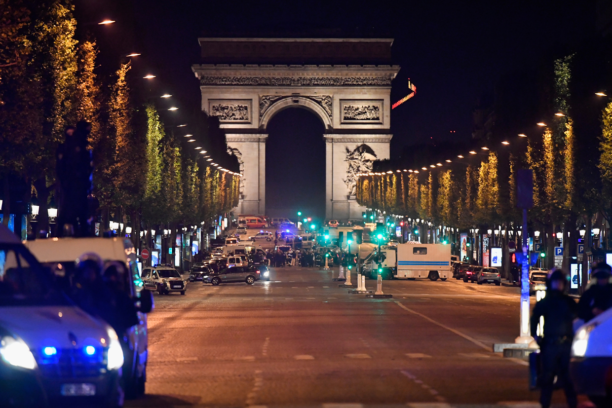 PARIS, FRANCE - APRIL 20: Police officers secure the area after a gunman opened fire on Champs Elysees on April 20, 2017 in Paris, France. One police officer has been killed, and a second injured by a gunman on The Champs Elysees. Security is heightened in Paris with the first round of France's presidential election on Sunday. (Photo by Jeff J Mitchell/Getty Images)