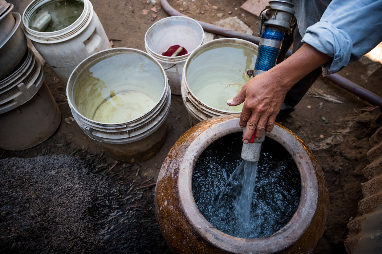 BEN TRE, VIETNAM - APRIL 28: Nguyen Thanh Nhat, 39, a water truck driver, pumps fresh water from his truck to client's storages on April 28, 2017 in Thua Duc Village, Binh Dai District, Ben Tre Province, Vietnam. Due to the lack of fresh water caused by salinization, people in Thu Duc Village need to buy fresh water from water truck from VND100,000 to VND200,000 (around US$4.5 to US$9) for 3 cubic meters. The Mekong River Delta is amongst the most vulnerable regions in South Vietnam, which is home to more than 17 million people and produces around half of the country's rice harvest with its fertile fields. However, climate change is causing the rise of salt content of water in land that has ben used for rice paddies, coconut groves and other crops, threatening the livelihoods of millions of farmers and fishermen. The Vietnamese government report have stated that 40 percent of the delta could be submerged if sea levels rise by one-meter in decades to come while residents in the low-lying delta have already been affected by more frequent typhoons and heavier floods that could potentially drive hundreds of thousands of people from their homes, according to reports. As many locals have been forced to abandon their rice cultivation due to salinization and risk their livelihood on other ventures such as shrimp farming, reports also state that cycles and storms linked to climate change would not only risk the Mekong Delta, but also up to the coffee crops in the highlands as well as the Red River Delta in the north, affecting large areas near the country's capital, Hanoi. (Photo by Linh Pham/Getty Images)