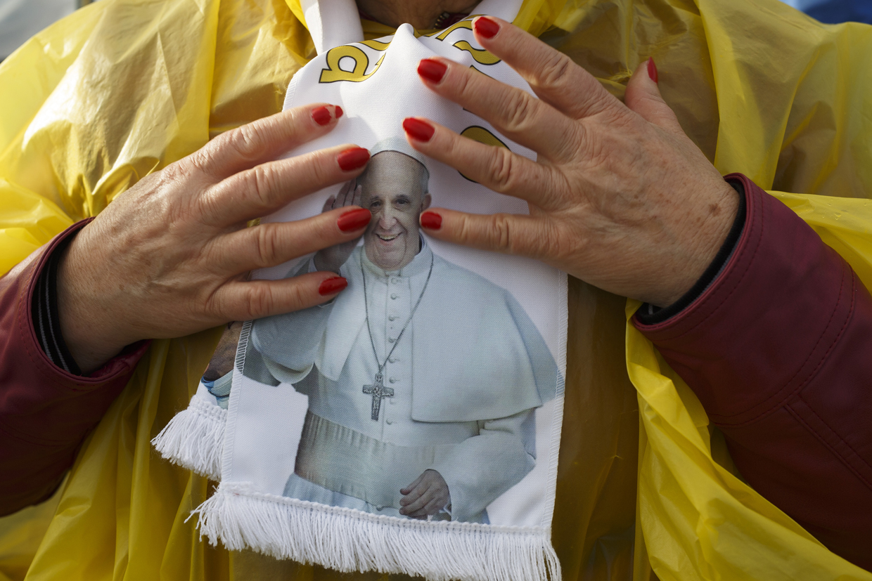 FATIMA, PORTUGAL - MAY 12: A worshipper touches her scarf with the image of Pope Francis in the Sanctuary of Fatima on May 12, 2017 in Fatima, Portugal. Pope Francis will be attending the Sanctuary of Fatima, in Portugal, on May 12 and 13 to canonize two Portuguese shepherds, Jacinta and Francisco Marto, who are said to have witnessed the apparition of what they believed was the Virgin Mary, together with their aunt Lucia Santos, during the 100 anniversary. Thousands of pilgrims and worshippers from around the world are expected to gather at the centenary celebration. (Photo by Pablo Blazquez Dominguez/Getty Images)