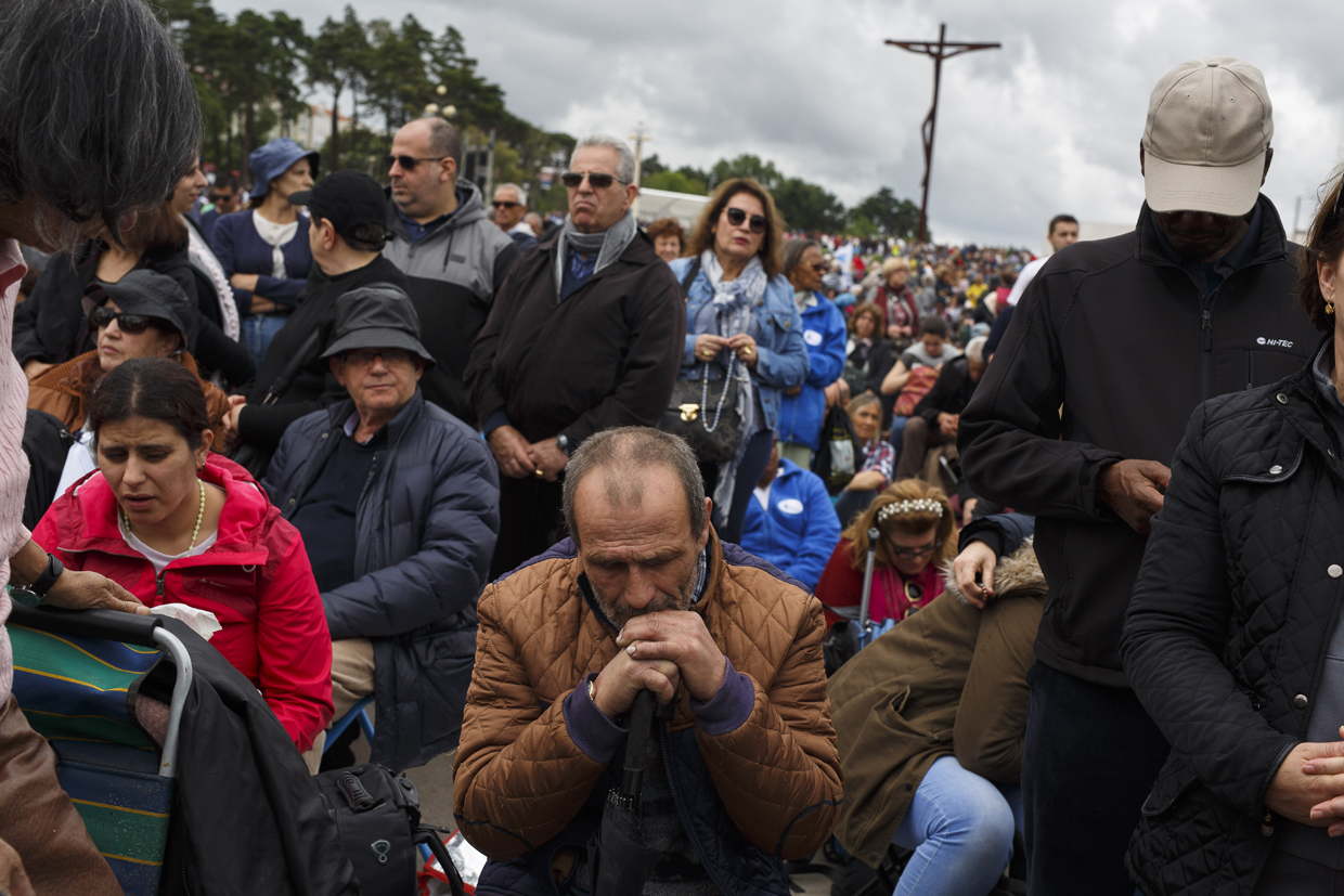 FATIMA, PORTUGAL - MAY 12: Worshippers pray as they wait for the arrival of Pope Francis at the Sanctuary of Fatima on May 12, 2017 in Fatima, Portugal. Pope Francis will be attending the Sanctuary of Fatima, in Portugal, on May 12 and 13 to canonize two Portuguese shepherds, Jacinta and Francisco Marto, who are said to have witnessed the apparition of what they believed was the Virgin Mary, together with their aunt Lucia Santos, during the 100 anniversary. Thousands of pilgrims and worshippers from around the world are expected to gather at the centenary celebration. (Photo by Pablo Blazquez Dominguez/Getty Images)