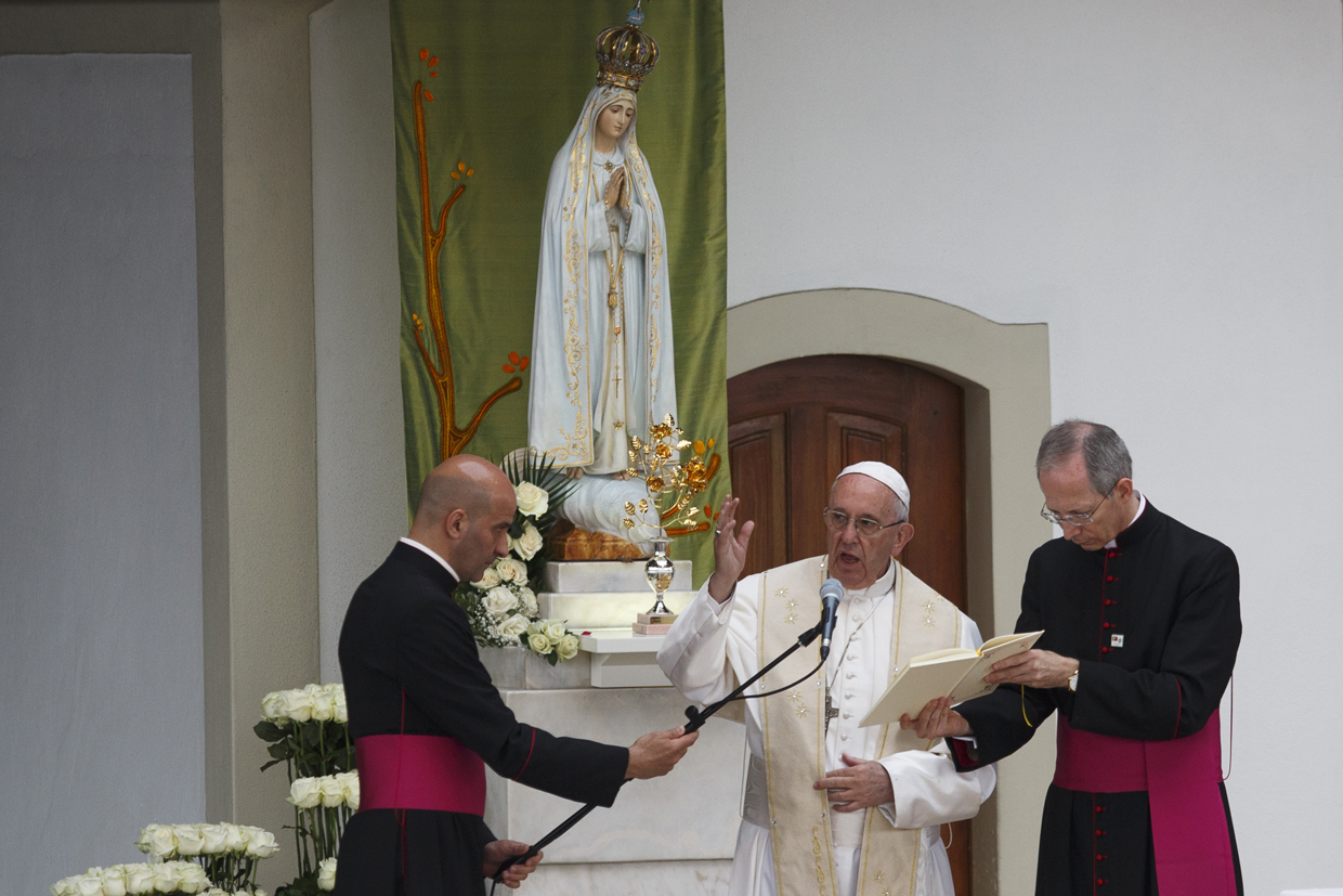 FATIMA, PORTUGAL - MAY 12: Pope Francis speaks next to a figure representing Our Lady Of Fatima at the Sanctuary of Fatima on May 12, 2017 in Fatima, Portugal. Pope Francis will be attending the Sanctuary of Fatima, in Portugal, on May 12 and 13 to canonize two Portuguese shepherds, Jacinta and Francisco Marto, who are said to have witnessed the apparition of what they believed was the Virgin Mary, together with their aunt Lucia Santos, during the 100 anniversary of the event. Thousands of pilgrims and worshippers from around the world are expected to gather at the centenary celebration. (Photo by Pablo Blazquez Dominguez/Getty Images)